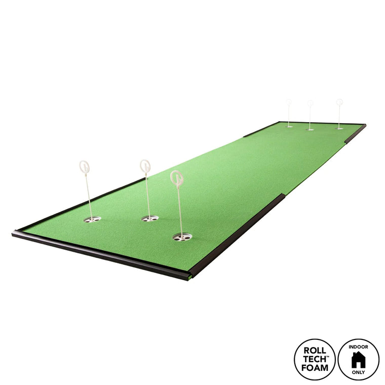 The BirdieBall Bigger-is-Better Ultimate Putting Mat Package (4' x 20'- 4' x 30') is a long indoor RollTech™ putting green with six holes and white flag markers. "Roll Tech Foam" and "Indoor Only" icons appear at the bottom right on a white background.