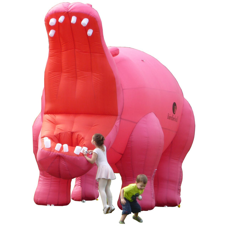 Two children enjoy the Golfopotamus | Large Inflatable Golf Target by BirdieBall, a big pink inflatable with an open mouth—ideal for fun golf training and practice with BirdieBalls on a white background.