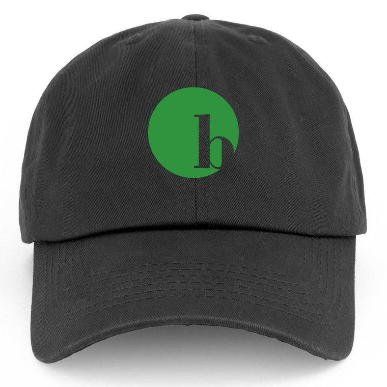 The BirdieBall Hat (Black Logo) by BirdieBall features a black design, an adjustable back strap for a perfect fit, and the classic green circle with a lowercase "h" on the front.